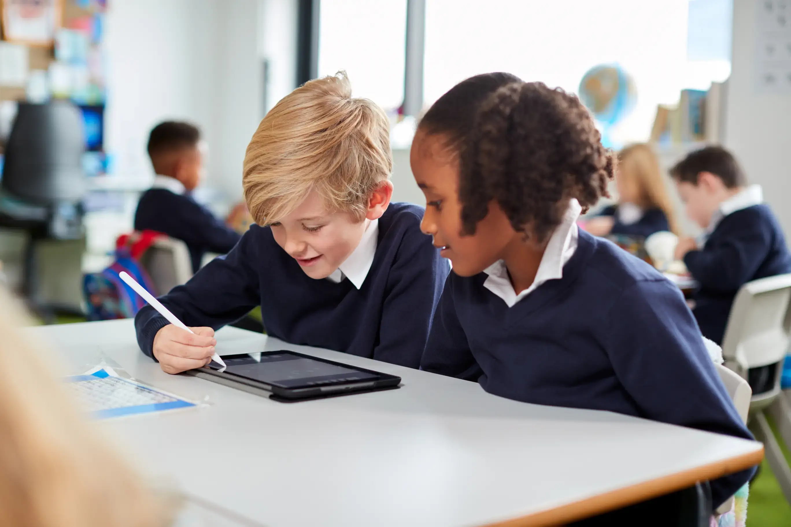 School children using a device with a pen 3