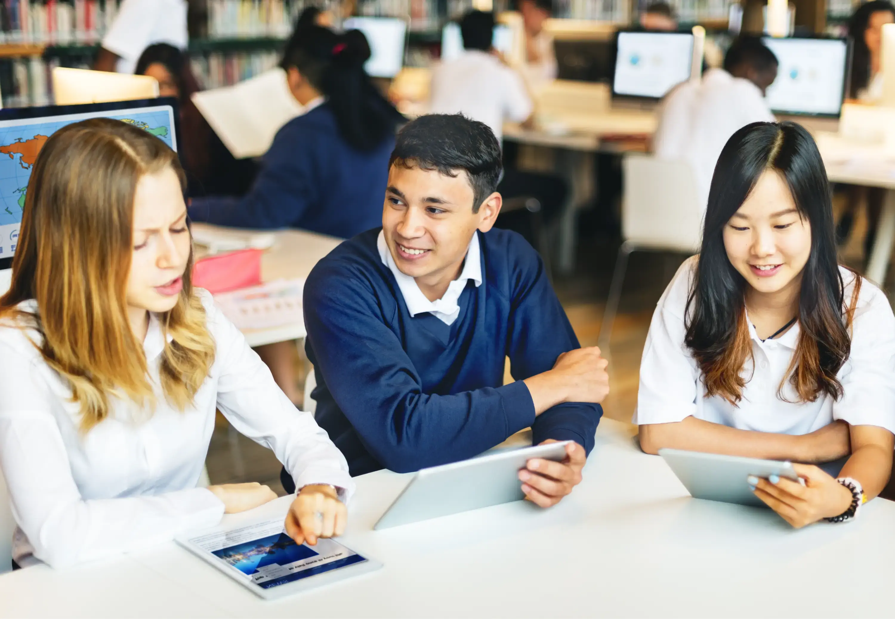 Students sat down using tablets