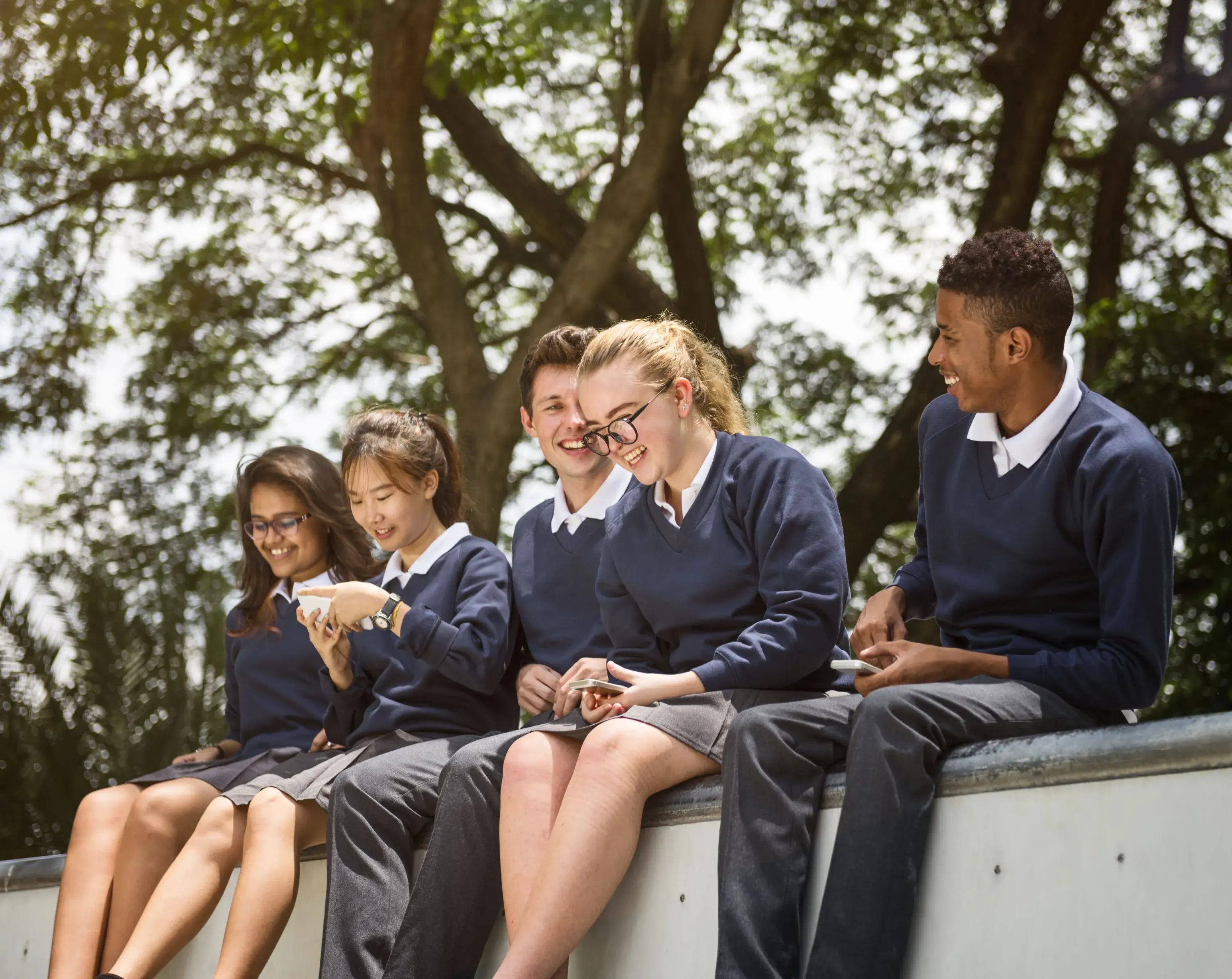 Secondary school students outside smiling 50percent